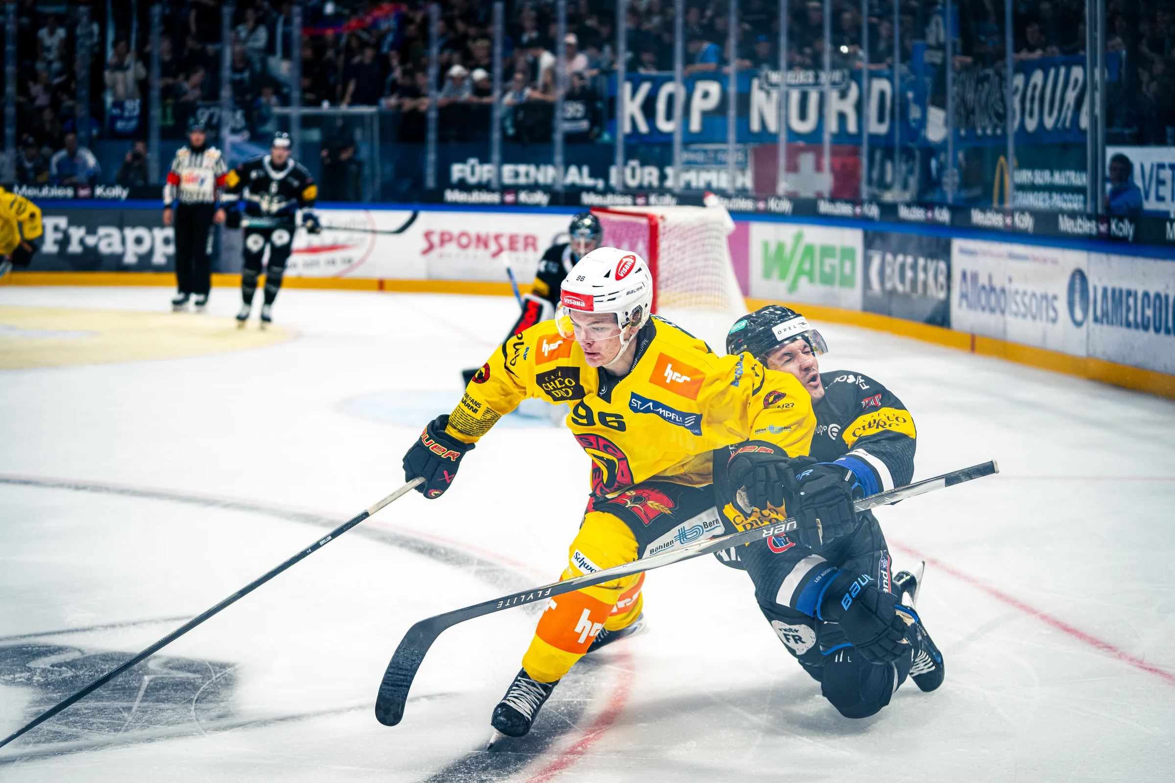 SC-Bern-Spieler in gelbem Trikot beim Kurvenfahren auf dem Eis